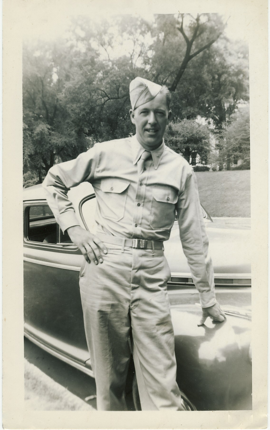 Lieutenant Wayne Proulx standing beside his car
